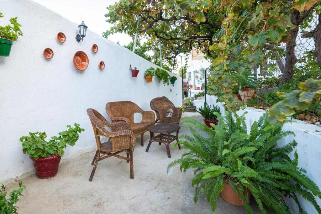 Shaded patio with wicker chairs and plants